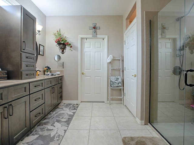 bathroom featuring vanity, tile patterned floors, and a shower with door