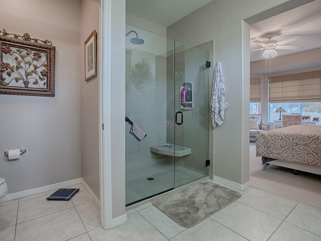 bathroom with tile patterned floors, ceiling fan, toilet, and walk in shower