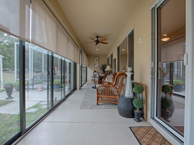 sunroom / solarium featuring ceiling fan