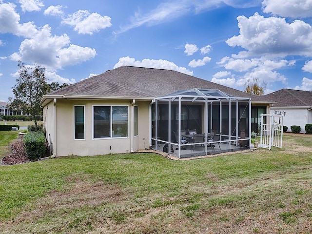 back of property featuring a lanai and a lawn