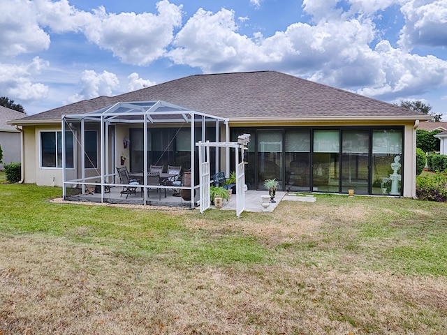 back of property with a lanai, a yard, and a patio