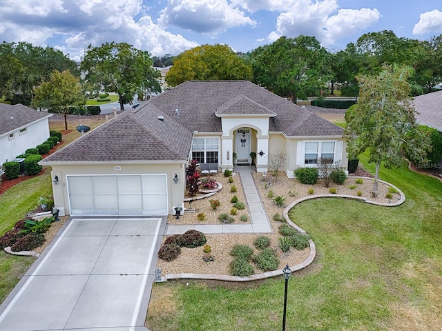 single story home featuring a garage and a front lawn