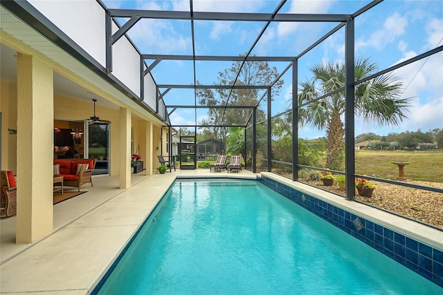 view of pool featuring a lanai, ceiling fan, and a patio area