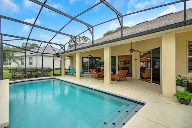 view of swimming pool with a lanai, a patio area, ceiling fan, and an outdoor living space