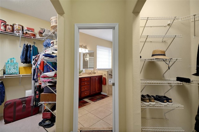 spacious closet with sink and light tile patterned floors