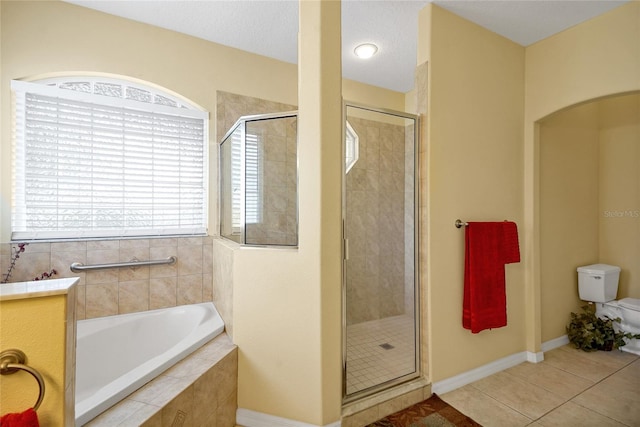 bathroom featuring toilet, a textured ceiling, tile patterned floors, and independent shower and bath