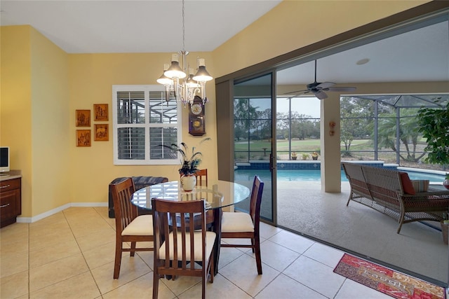 dining area featuring ceiling fan with notable chandelier, plenty of natural light, and light tile patterned flooring