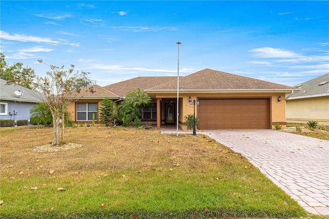 ranch-style house with a front yard and a garage