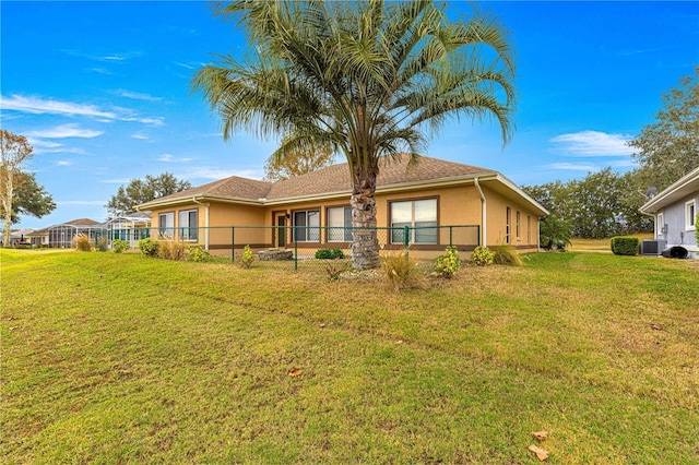 rear view of property with a yard