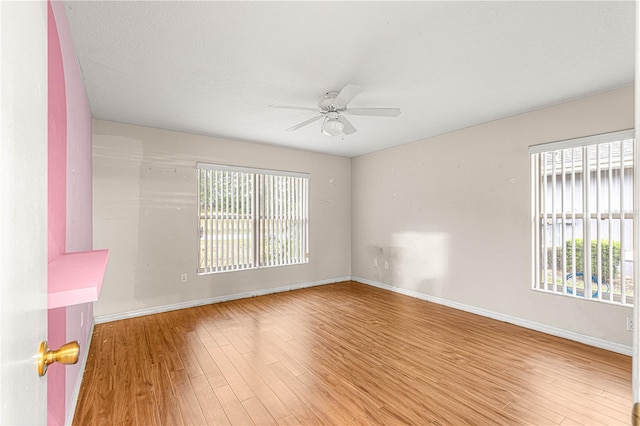 empty room featuring hardwood / wood-style floors, a textured ceiling, plenty of natural light, and ceiling fan