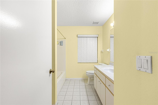 bathroom with tile patterned flooring, vanity, a textured ceiling, and toilet