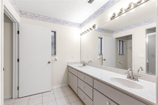 bathroom featuring tile patterned floors, vanity, and a textured ceiling