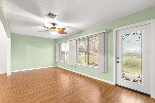 unfurnished sunroom featuring ceiling fan