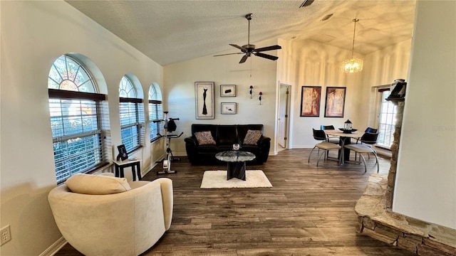 living room featuring a textured ceiling, dark hardwood / wood-style floors, ceiling fan with notable chandelier, and vaulted ceiling