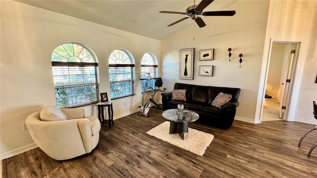 living room featuring a textured ceiling, dark hardwood / wood-style flooring, ceiling fan, and lofted ceiling