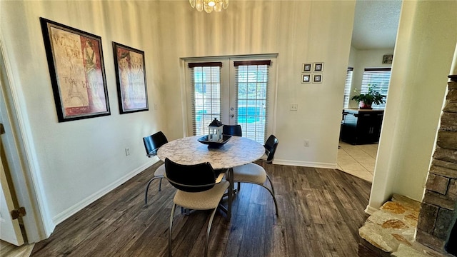 dining space featuring french doors, dark wood-type flooring, and a textured ceiling