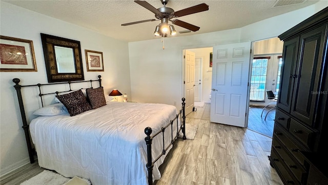 bedroom featuring access to exterior, a textured ceiling, light wood-type flooring, and ceiling fan