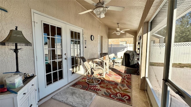 sunroom / solarium with ceiling fan, french doors, and vaulted ceiling