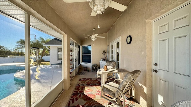 sunroom / solarium featuring ceiling fan and vaulted ceiling