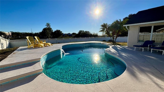 view of swimming pool with a patio and pool water feature