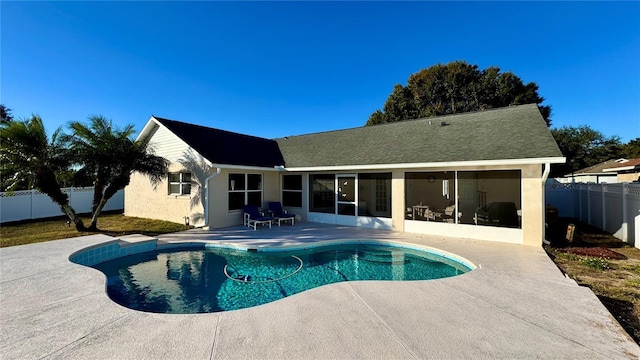 view of pool featuring a sunroom and a patio