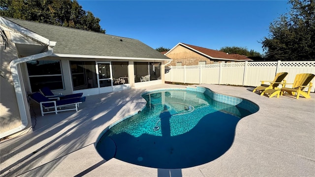 view of pool with a sunroom and a patio