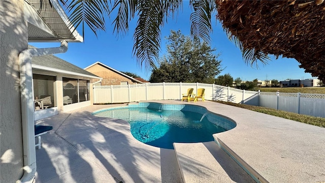 view of swimming pool with a sunroom and a patio