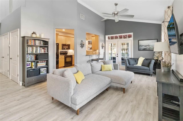 living room featuring french doors, light hardwood / wood-style floors, high vaulted ceiling, and ceiling fan