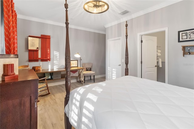 bedroom with light hardwood / wood-style floors and crown molding