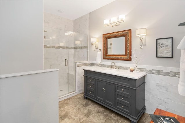 bathroom with walk in shower, vanity, and tile walls