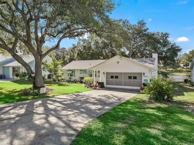 ranch-style house featuring a garage and a front lawn