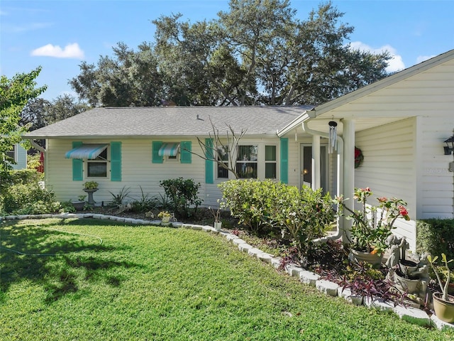 ranch-style house featuring a front lawn