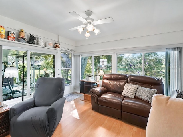 sunroom / solarium featuring ceiling fan