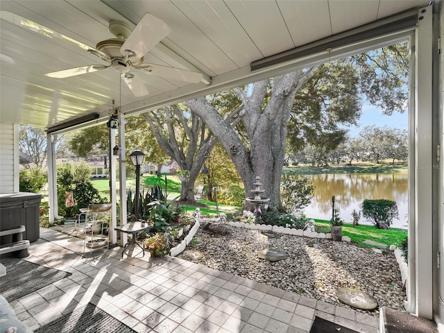 view of patio / terrace with a water view and ceiling fan