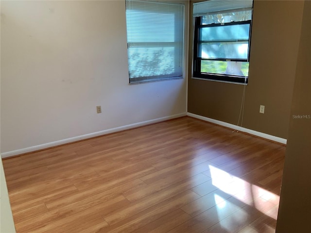 spare room with light wood-type flooring