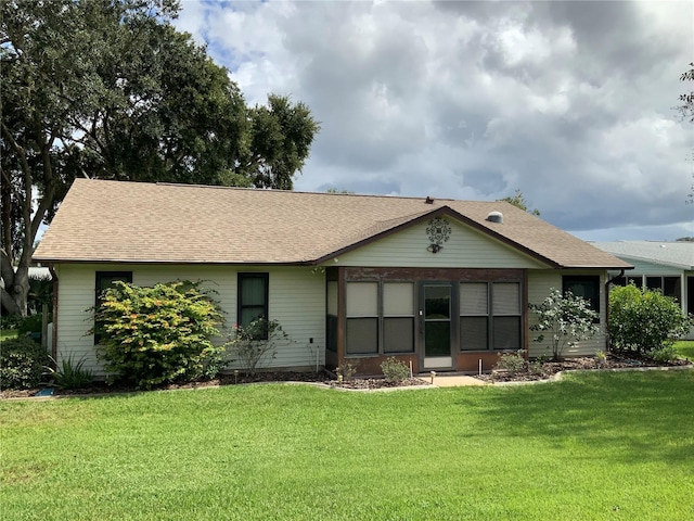 rear view of house with a lawn