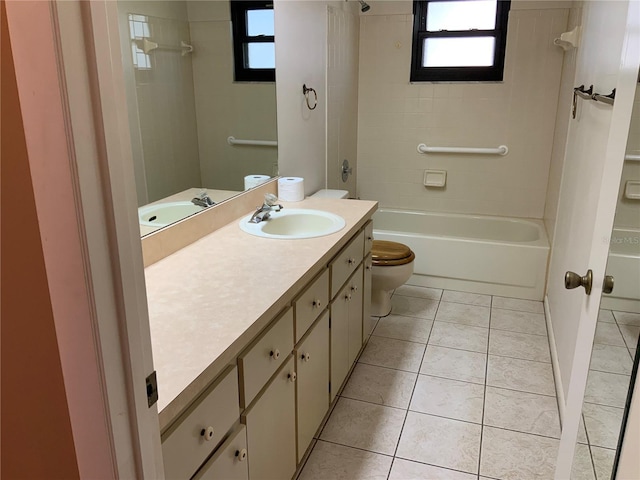 full bathroom with tile patterned flooring, vanity, tiled shower / bath combo, and toilet