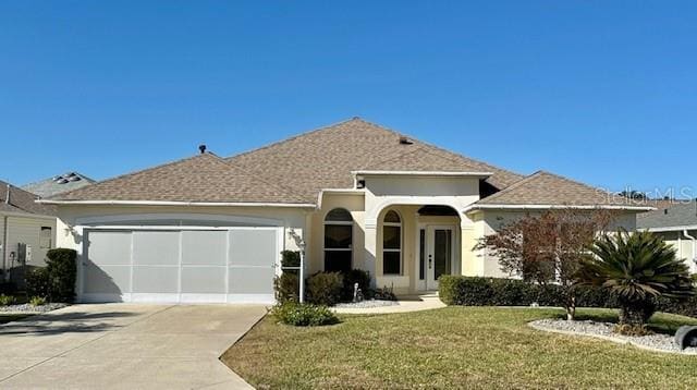 view of front of home featuring a garage and a front yard