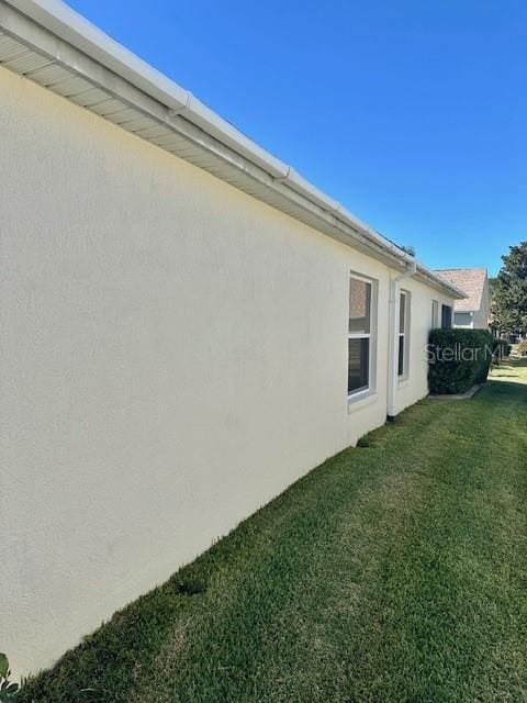 view of side of home with a lawn