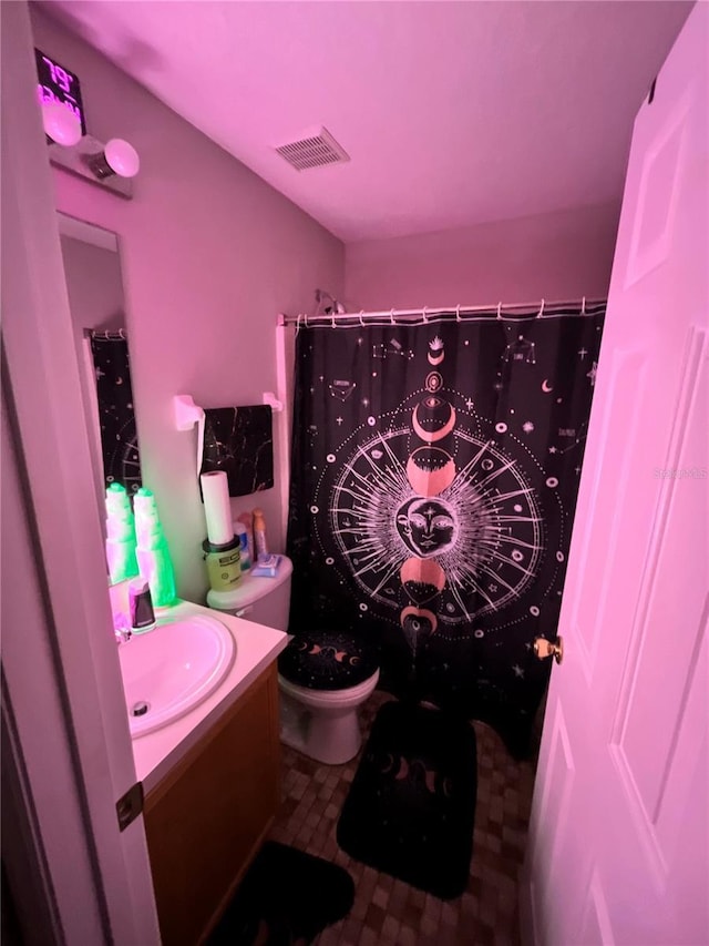 bathroom with a shower with shower curtain, vanity, and toilet