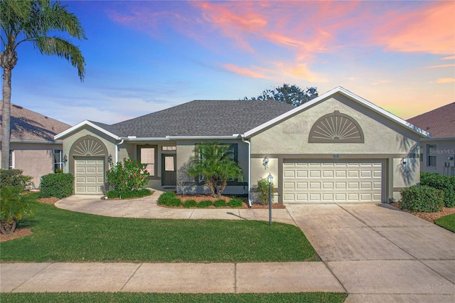 ranch-style home with a lawn and a garage