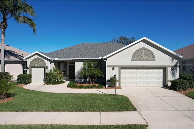 single story home with a front yard and a garage