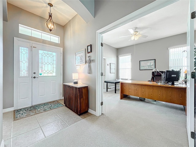 foyer entrance with light carpet and ceiling fan