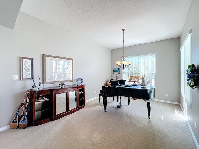 miscellaneous room featuring a wealth of natural light, carpet floors, a textured ceiling, and a notable chandelier