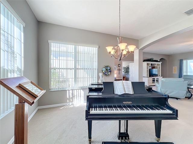 miscellaneous room with carpet floors and a notable chandelier