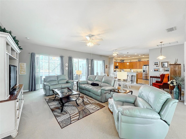 living room featuring ceiling fan and light carpet