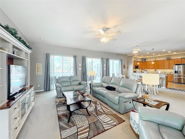 living room featuring ceiling fan and light colored carpet