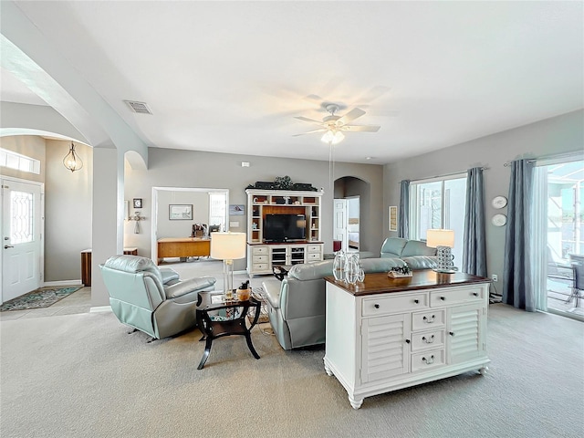 carpeted living room featuring ceiling fan