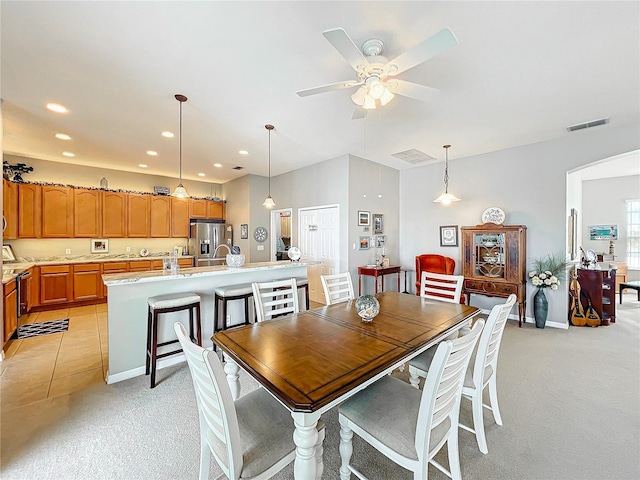 carpeted dining space with ceiling fan