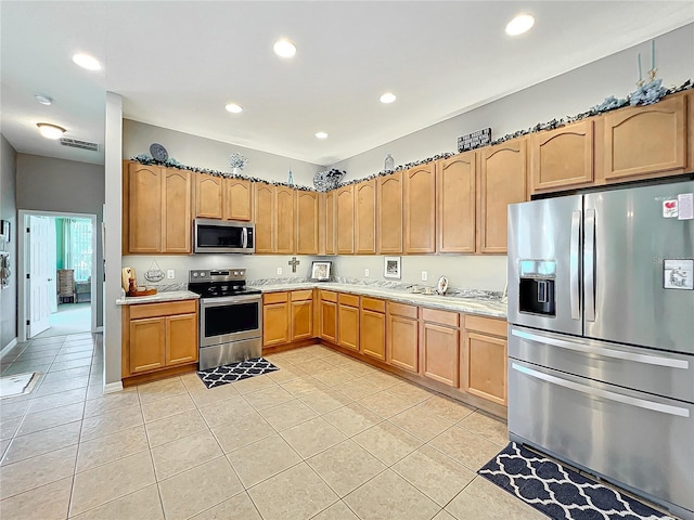 kitchen with light tile patterned flooring and stainless steel appliances